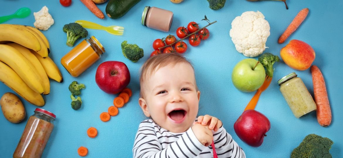 Baby,Surrounded,With,Fruits,And,Vegetables,On,Blue,Blanket,,Healthy