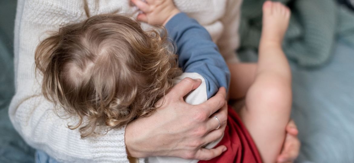 Mother,Breastfeeding,Baby,,Rear,View.,Woman,With,Baby,,Mother,Gently